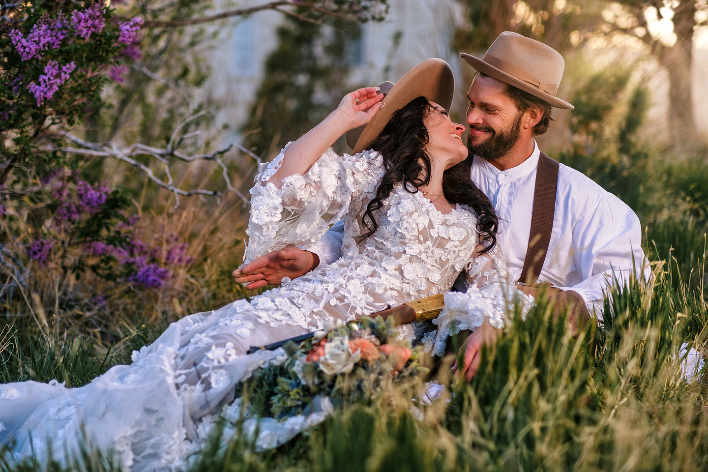 A newlywed couple sitting together outdoors