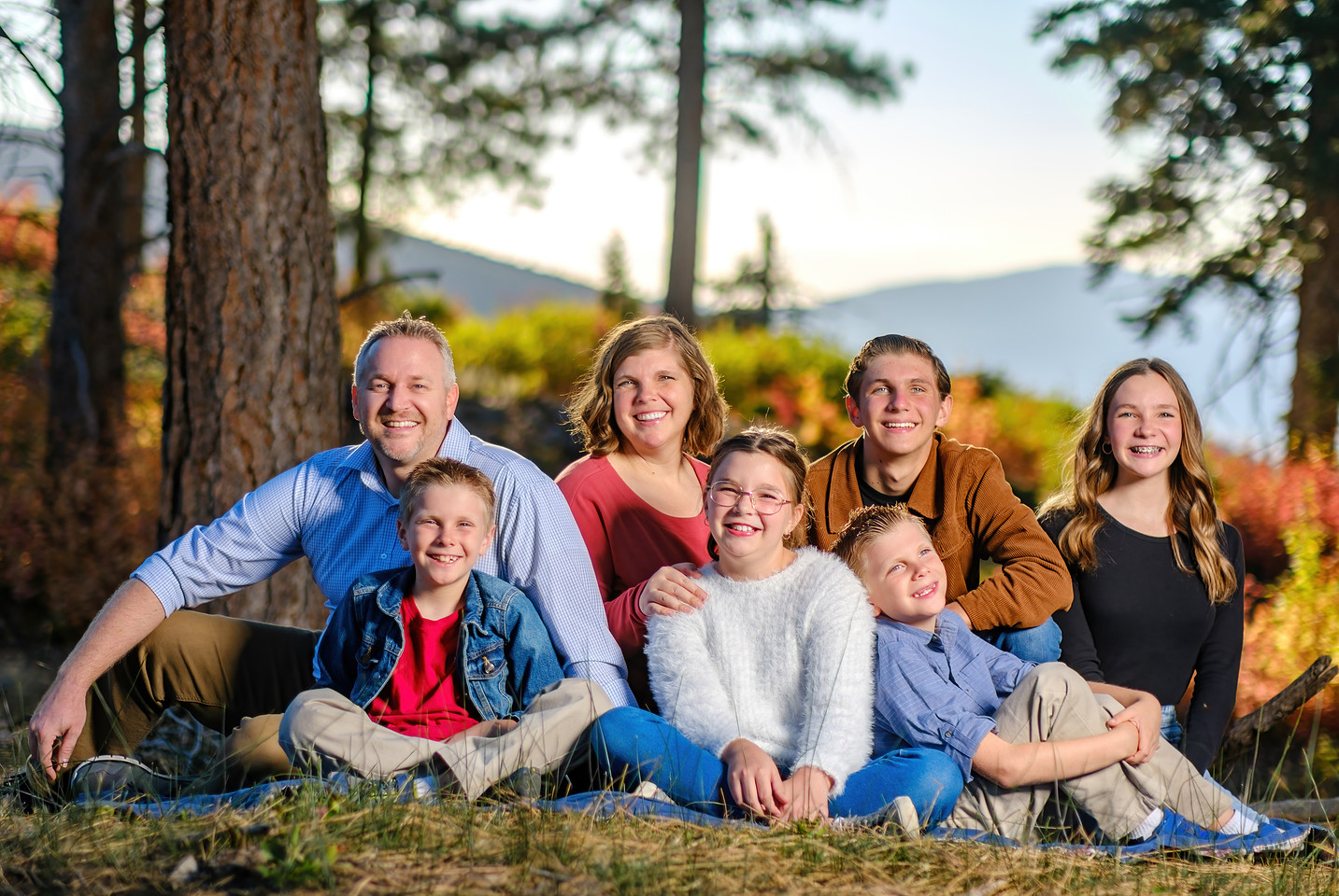 A family photographed outdoors in the mountains