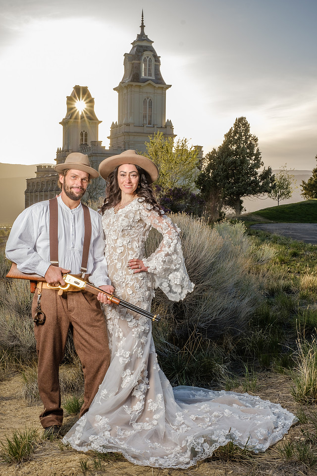 A couple photographed in evening light at the Manti Utah Temple